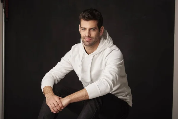 Handsome young man sitting — Stock Photo, Image