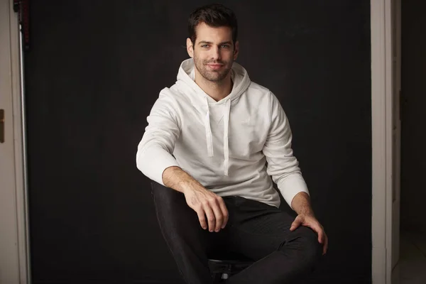 Handsome young man sitting — Stock Photo, Image