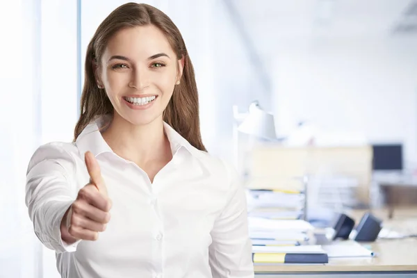 Businesswoman giving thumb up while standing — Stock Photo, Image