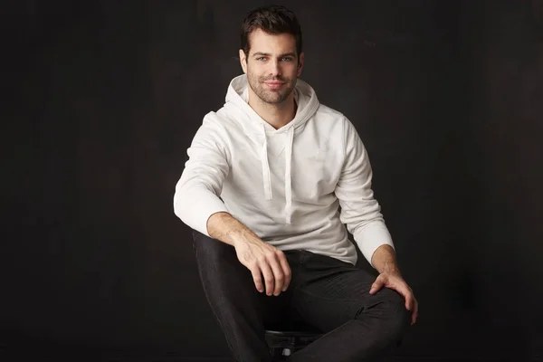 A handsome young man sitting — Stock Photo, Image