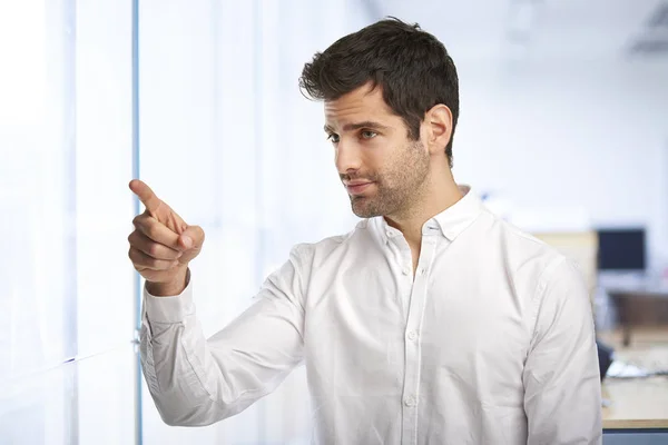 Portrait Smiling Young Businessman Pointing Something His Finger While Standing — Stock Photo, Image