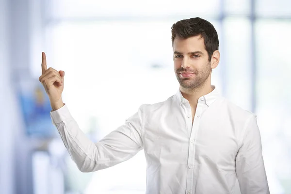 Portrait Smiling Young Businessman Pointing Something His Finger While Standing — Stock Photo, Image