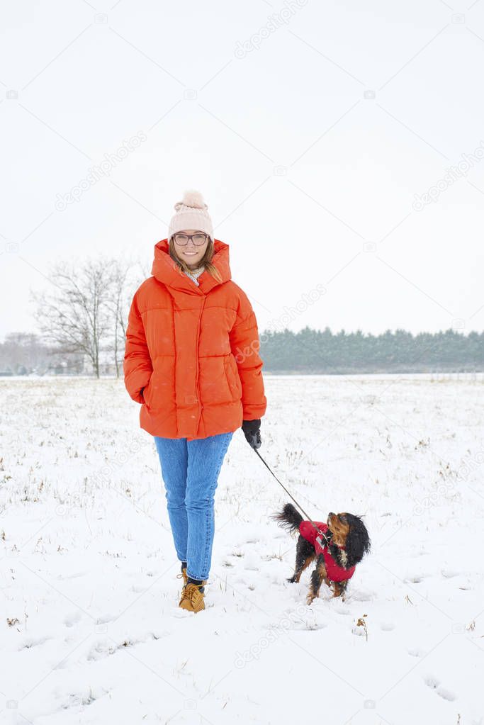 woman walking her small dog