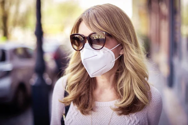 中年妇女在街上行走时戴着防毒面具进行健康保护 同时迅速在城市传播高头牛病毒疫情的特写镜头 — 图库照片