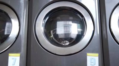 Commercial washing machines working in a laundrette