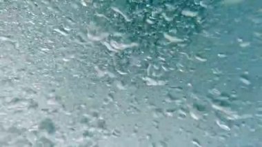 Abstract. Bubbles moving in a swirling pattern underwater saltwater footage