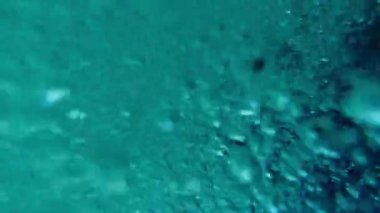 Abstract. Bubbles moving in a swirling pattern underwater saltwater footage