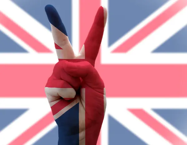 Union Jack Flag with hand in Victory pose — стокове фото