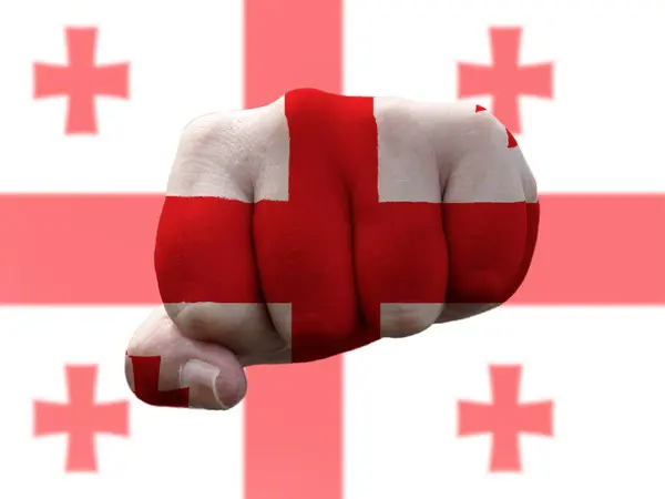 Georgia Flag painted on human fist representing power - Stock-foto