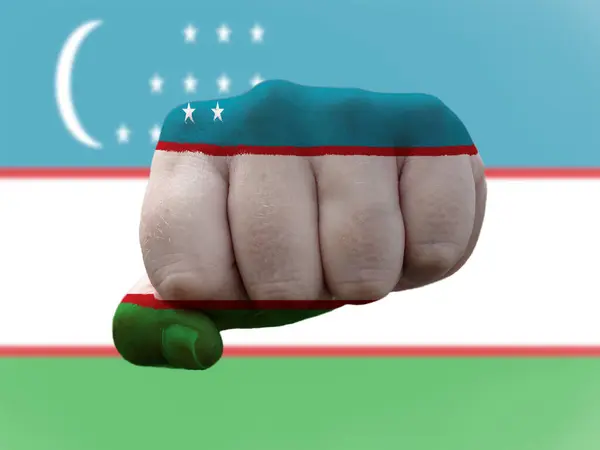 Uzbekistan Flag painted on human fist representing power — Stock Photo, Image