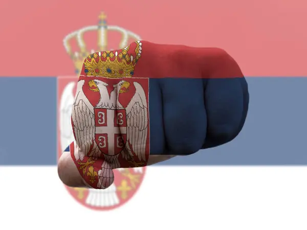 Serbia Flag painted on human fist representing power — Fotografie, imagine de stoc