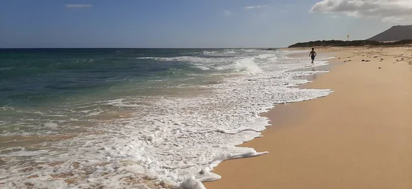 Fuerteventura sahilinde koşan çocuk. 