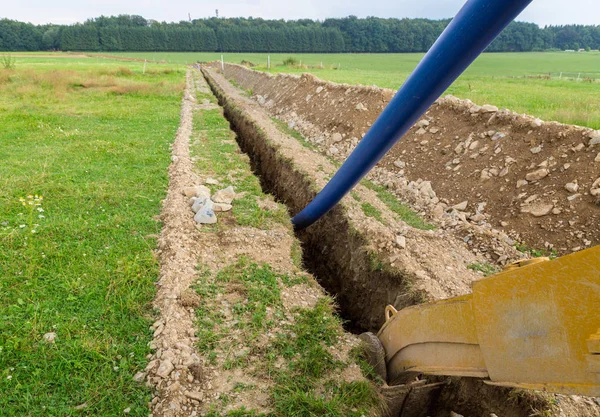 Pipe laying construction site on a meadow — Stock Photo, Image