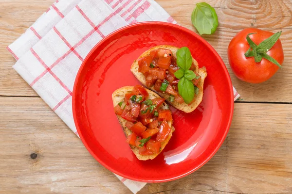 Bruschetta with tomatoes on a wooden board — Stock Photo, Image