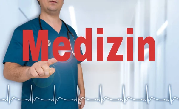 Medizin (in german Medical) doctor showing on viewer with heart — Stock Photo, Image