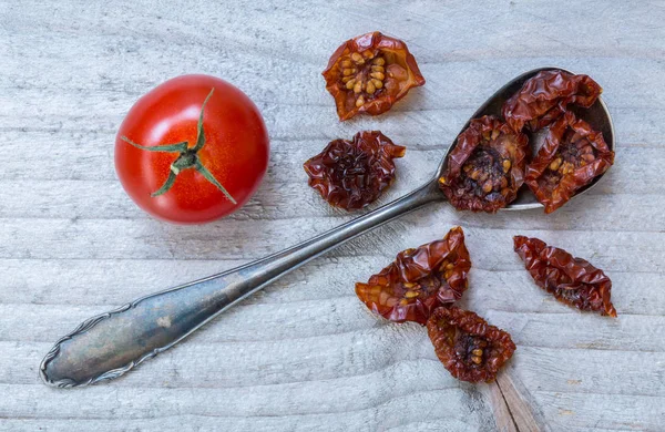 Dried tomatoes on a spoon macro — Stock Photo, Image