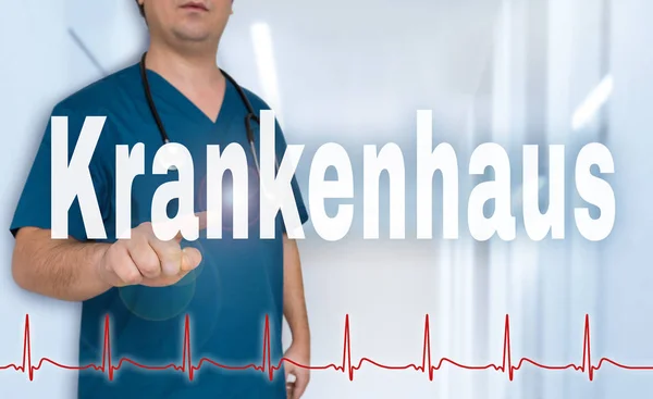 Krankenhaus (in german Hospital) doctor showing on viewer with h — Stock Photo, Image