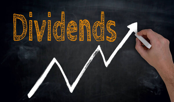 Dividends and graph is written by hand on blackboard