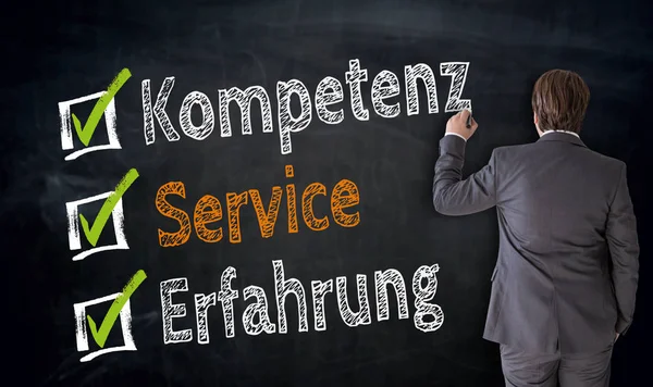 Бизнесмен пишет Kompetenz, Service, Erfahrung (на немецком языке comp — стоковое фото