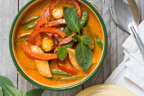 Red Thai curry in a bowl on wooden table — Stock Photo, Image