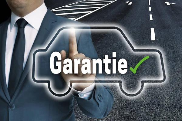 Garantie (in german Warranty) with car touchscreen is operated b — Stock Photo, Image