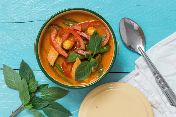 Red Thai curry in a bowl on turquoise wooden table — Stock Photo, Image