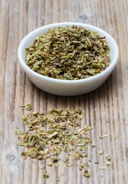 Oregano in a bowl on wood — Stock Photo, Image