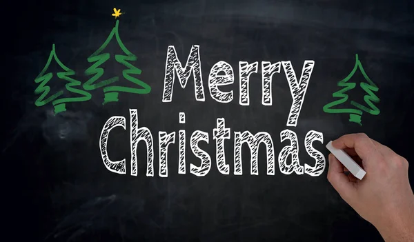 Merry Christmas is written by hand on blackboard — Stock Photo, Image