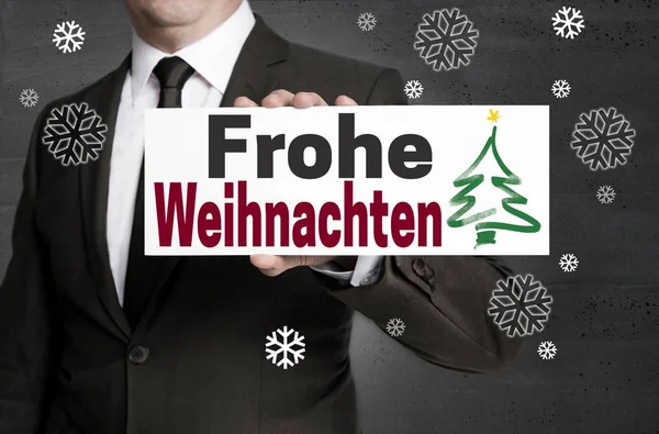 Jelzőtábla Frohe Weihnachten (a német boldog karácsonyt) tartott — Stock Fotó