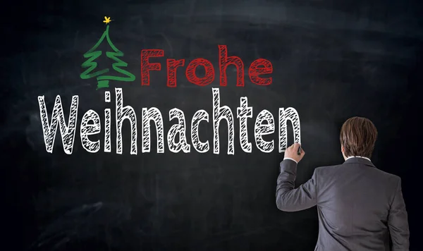 Üzletember írja Frohe Weihnachten (a német boldog karácsonyt) — Stock Fotó