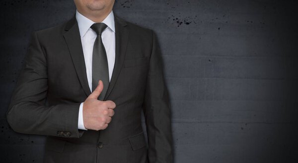 Businessman with thumbs up and copyspace