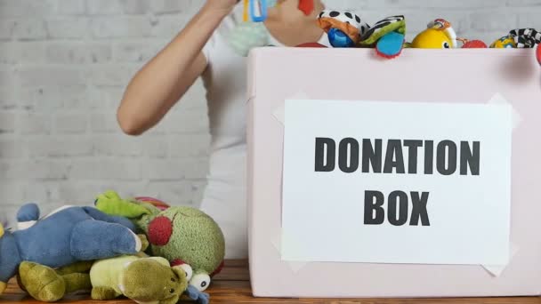 Woman prepare to donate toys in charity shop. Slow motion — Stock Video