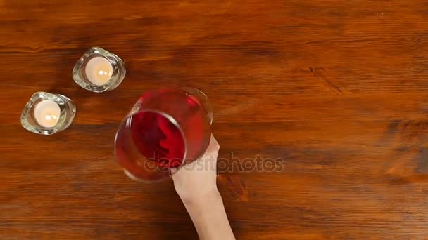 Woman testing red wine in restaurant, top view — Stock Video