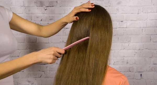 Мати розчісує дочку довге волосся після ванної — стокове фото