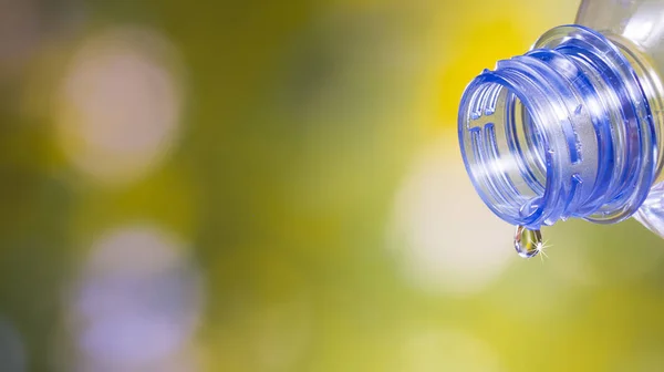 Drop of cool water with sunshine pouring from a clean plastic bottle.