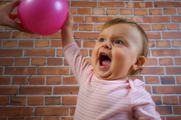Funny little cute baby girl in pink with ball playing basketball — Stock Photo, Image