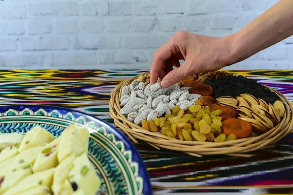 女人在咖啡馆，撒马尔罕，乌兹别克斯坦以从表一些东方的糖果 — 图库照片