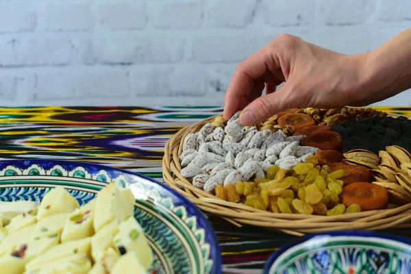 Close-up view, woman hands taking some oriental sweets, Samarkand, Uzbekistan — Stock Photo, Image