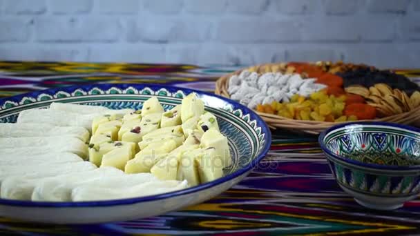 Hand take some traditional oriental sweets from ceramic dish, Samarkand, Uzbekistan — Stock Video