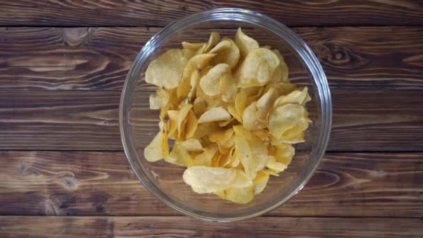 Woman taking crisps from glass bowl, top view hd video — Stock Video