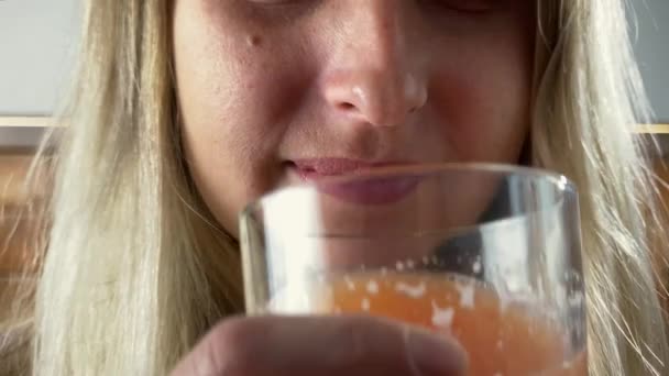 La mujer está bebiendo zumo de cítricos naturales frescos — Vídeos de Stock