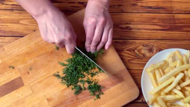 Girl is cutting the fennel with a knife for meals in the kitchen — Stock Video