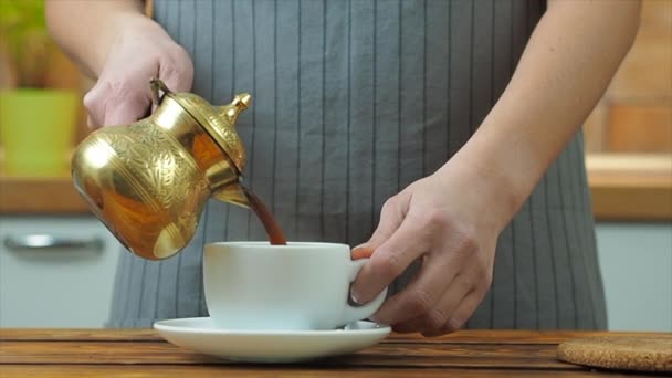 Woman pouring black coffee from turkish traditional coffee pot — 비디오