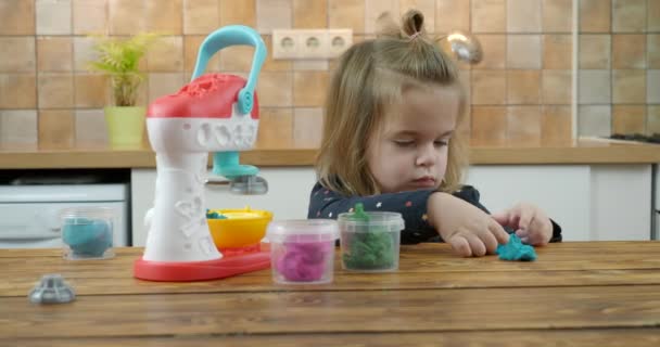 Little baby girl playing with colorful dough — 비디오