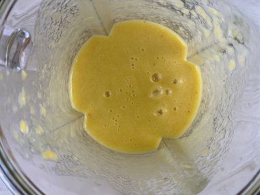 Process of cooking mango smoothie in the blender, slow motion