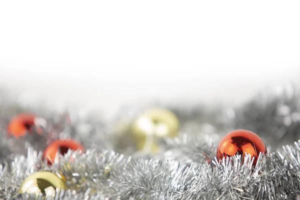 Christmas copy przestrzeń z czerwonym i złotym jaskrawych bombki w srebrnym łańcuchu dekoracyjnym na dole na białym tle i efekt bokeh — Zdjęcie stockowe