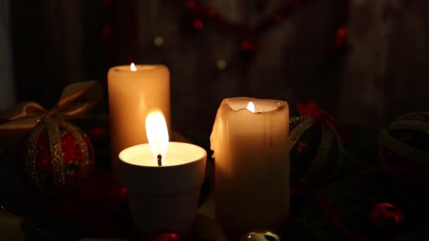 Warmth Christmas Three Lighted Candles One Large Flame Foreground Red — Stockvideo