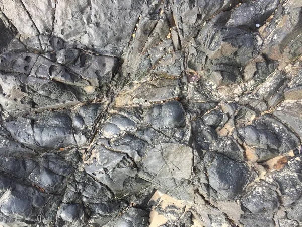 close-up natural textured of black rock surface.