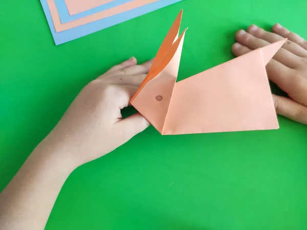 Origami step by step. How to make a paper bunny for Easter greetings