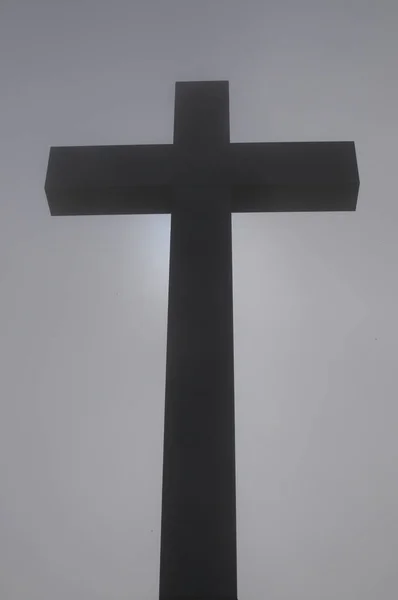 Religious cross in the fog
